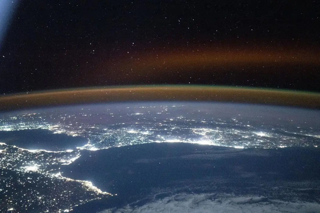 یک تابش هوازی سرخ‑زرد افق زمین را می‌پوشاند، در حالی که نورهای شهرهای جنوب‑غربی اروپا و شمال‑آفریقا در تضاد با اقیانوس اطلس و دریای مدیترانه که دو قاره را از هم جدا می‌کند، می‌درخشند. ایستگاه فضایی بین‌المللی در ارتفاع ۲۶۲ مایل (حدود ۴۲۲٫۲ کیلومتر) بالای اقیانوس اطلس، حدود ساعت ۱۹:۴۷ به وقت محلی، هنگام عکاسی در مدار بود.